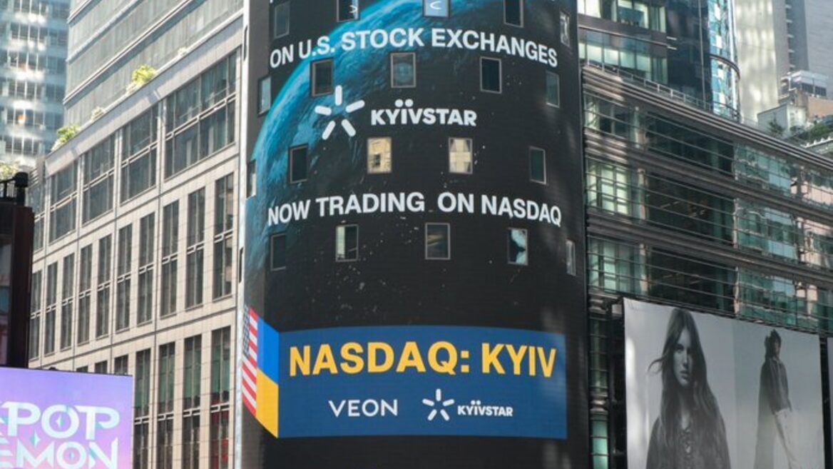 Cylindrical digital billboard in a city announcing NASDAQ: KYIV for Kyivstar with the Earth graphic and 'Now trading on NASDAQ' text. Cylindrical digital billboard in a city announcing NASDAQ: KYIV for Kyivstar with the Earth graphic and 'Now trading on NASDAQ' text.