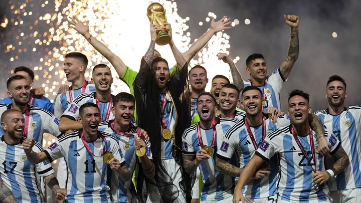 Argentina's Lionel Messi lifts the trophy after winning the World Cup final soccer match between Argentina and France at the Lusail Stadium in Lusail, Qatar, Sunday, Dec. 18, 2022. Argentina won 4-2 in a penalty shootout after the match ended tied 3-3. (AP Photo/Martin Meissner)