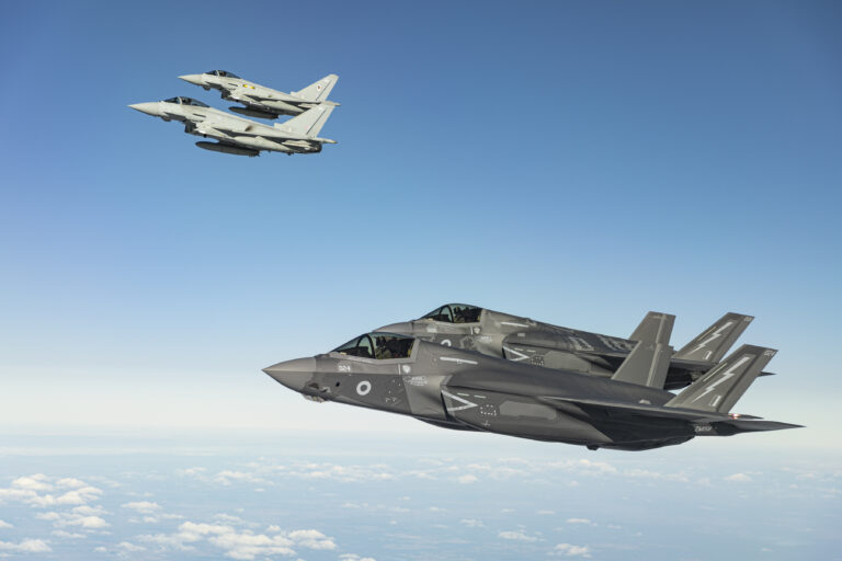 Image shows RAF F-35 aircraft working along side Typhoon FGR4 in  NATO’s Enhanced Vigilance Patrols for the first time.


THE RAF’s newest 5th Generation Fighter Jets have joined Typhoon FGR4 jets conducting NATO’s Enhanced Vigilance Patrols for the first time.

The Lightnings from RAF Marham joined the Typhoons taking part in pre-planned Enhanced Vigilance Activity, which is a NATO led Operation initiated due to the unfolding events in Ukraine. This activity providing air support ready to defend the region and is a robust response to Russian aggression, contributing to the security of Europe.

The RAF are contributing additional Typhoon FGR4 aircraft, flying from both RAF Coningsby in Lincolnshire and RAF Akrotiri in Cyprus as well as F-35 as to the NATO Mission. Armed with state-of-the-art Air-to-Air missiles and a full suite of defensive aids, the aircraft are patrolling NATO airspace over Poland and Romania, once more demonstrating the UK’s unwavering commitment to the NATO Alliance.

The aircraft were supported by RAF Voyager Air-to-air refuelling aircraft from Brize Norton, who offer additional fuel for the fighters so enabling greater range, providing greater mission endurance and showing the reach of UK air power to support NATO’s defence mission.