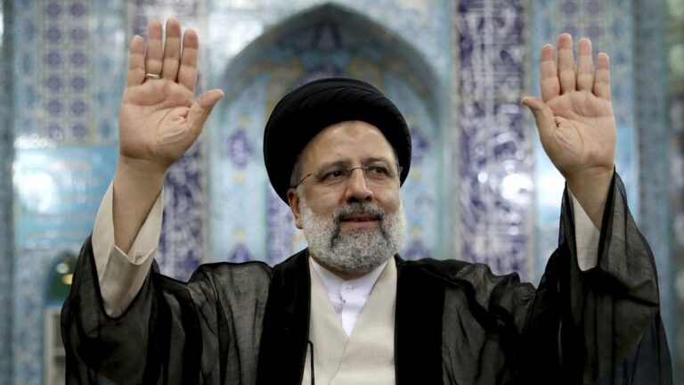 Ebrahim Raisi, a candidate in Iran's presidential elections waves to the media after casting his vote at a polling station in Tehran, Iran Friday, June 18, 2021. Iran began voting Friday in a presidential election tipped in the favor of a hard-line protege of Supreme Leader Ayatollah Ali Khamenei, fueling public apathy and sparking calls for a boycott in the Islamic Republic. (AP Photo/Ebrahim Noroozi)